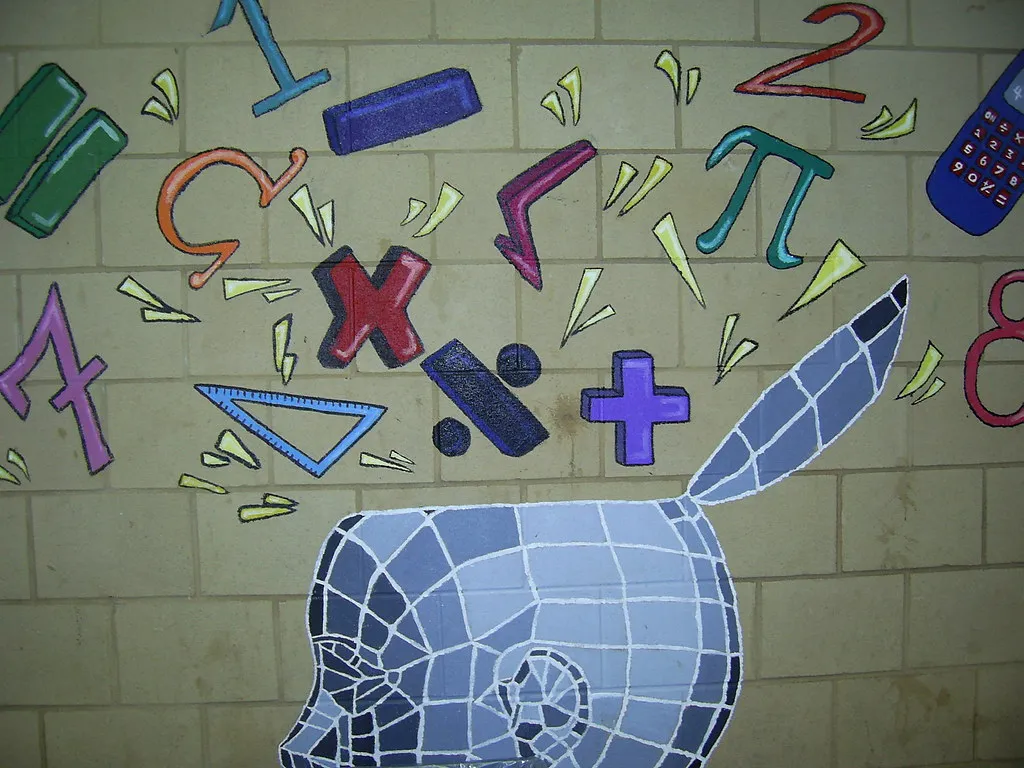 A school wall mural of a stylised head with numbers, a pi symbol, a set square and a calculator spilling out of it